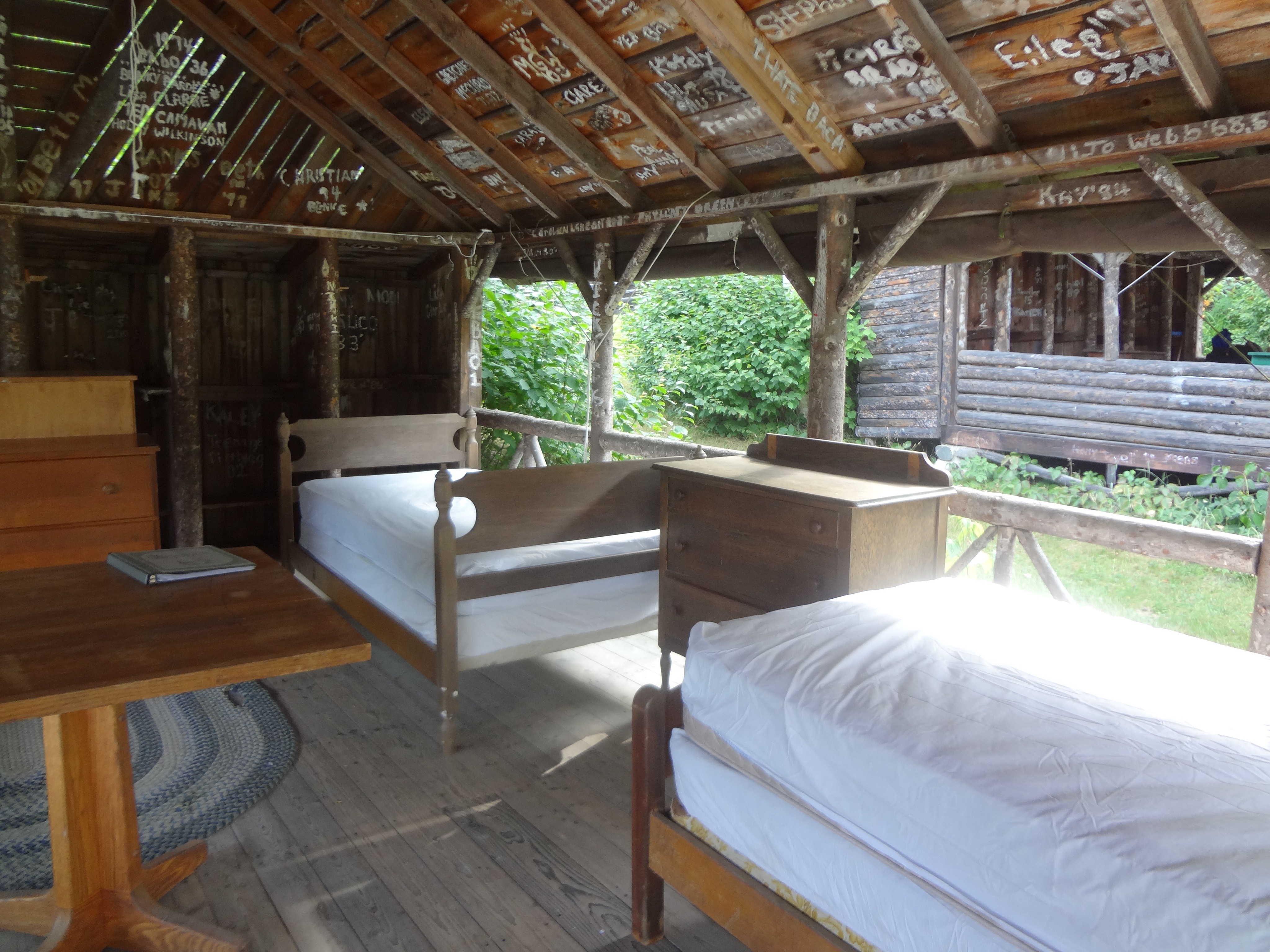 Adirondack cabin interior with beds and warm wood