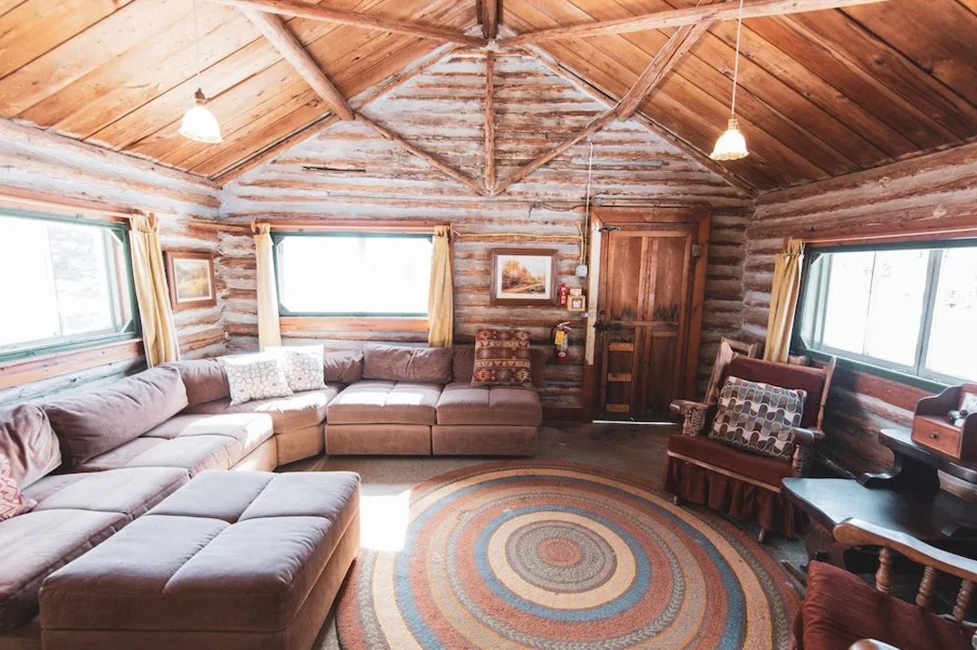 Cozy cabin interior with sectional sofa