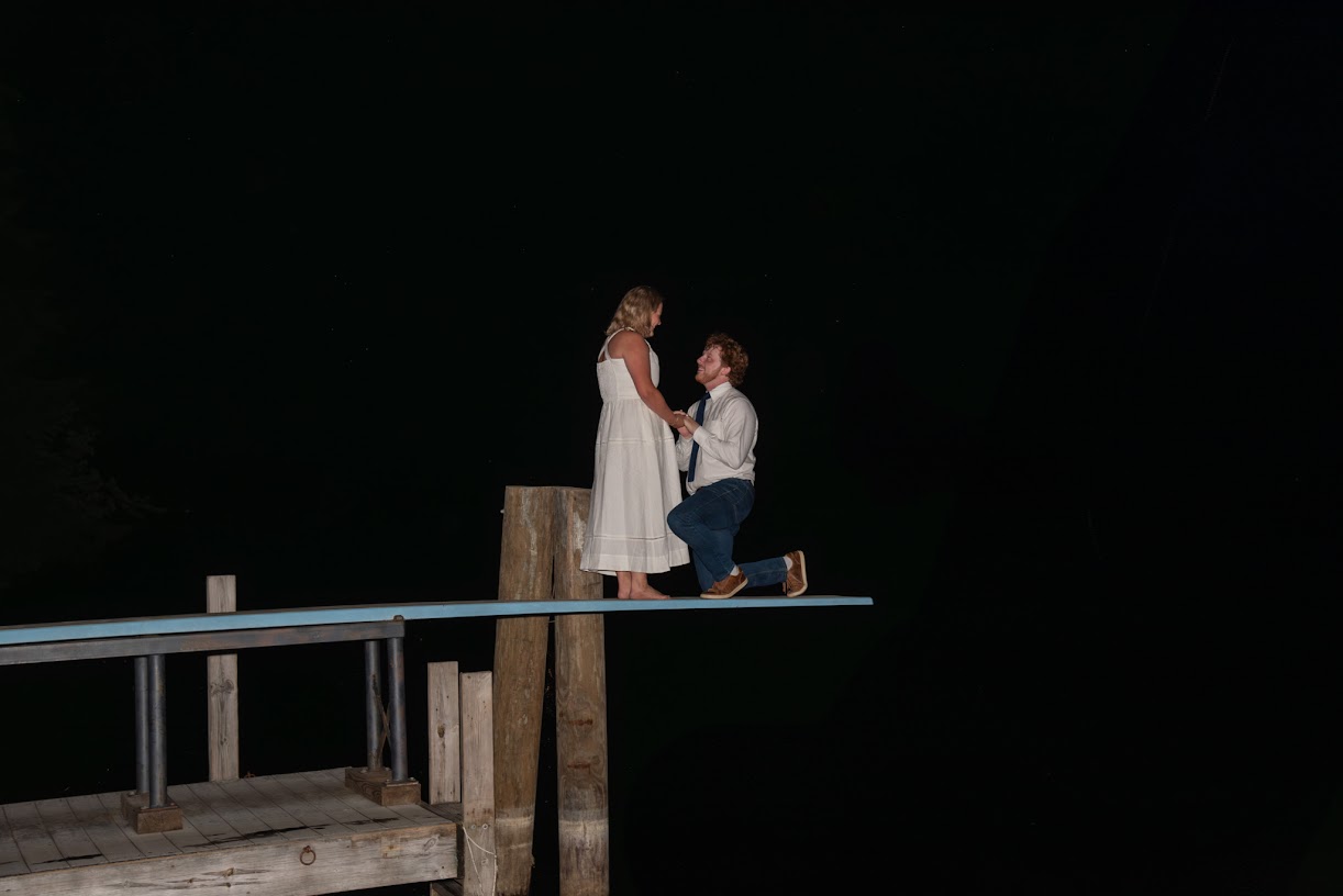 Alex proposing to Anna on the diving board at Three Mile Island under the stars, 2025