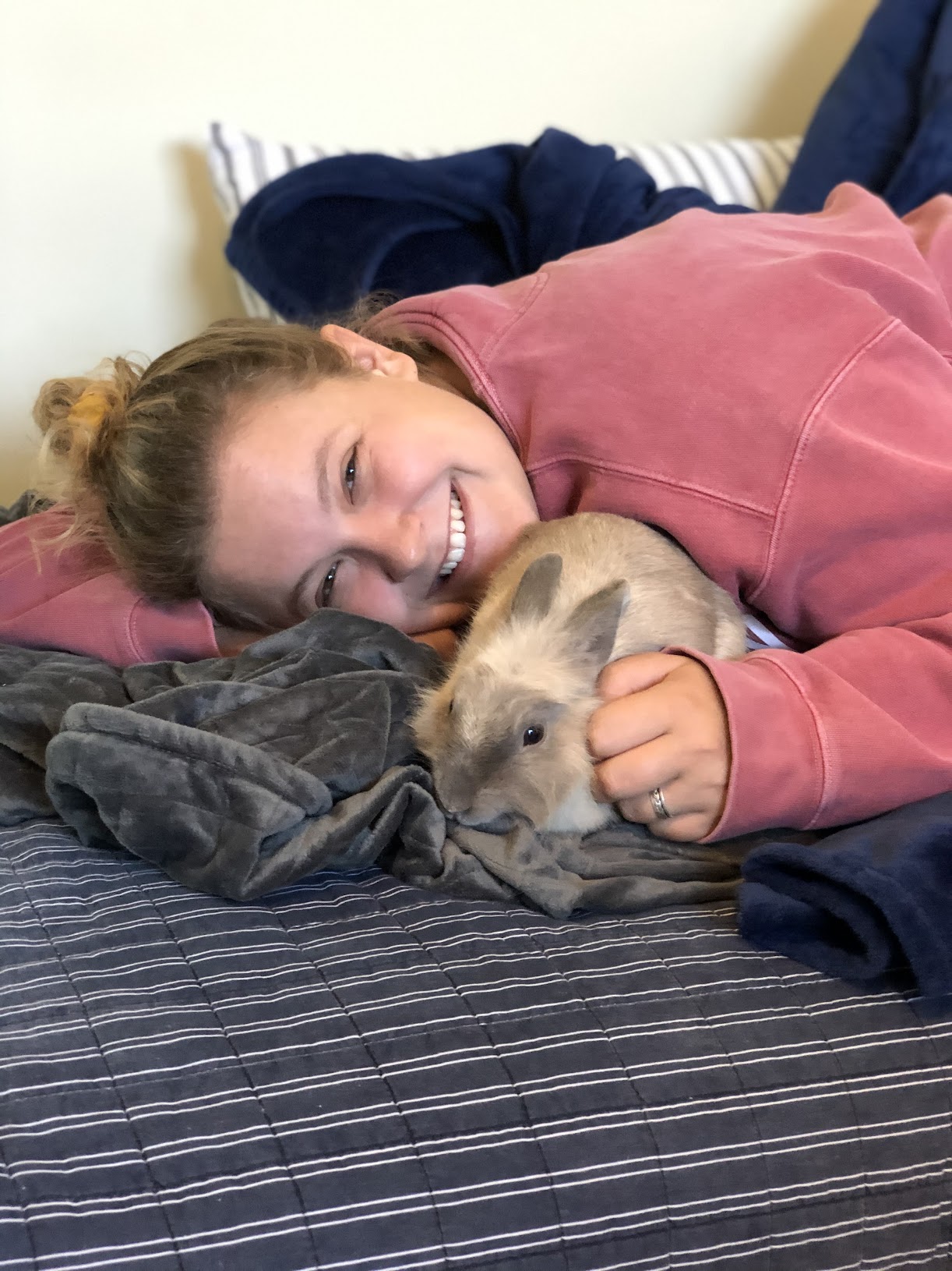 Anna cuddling Nabby on the bed