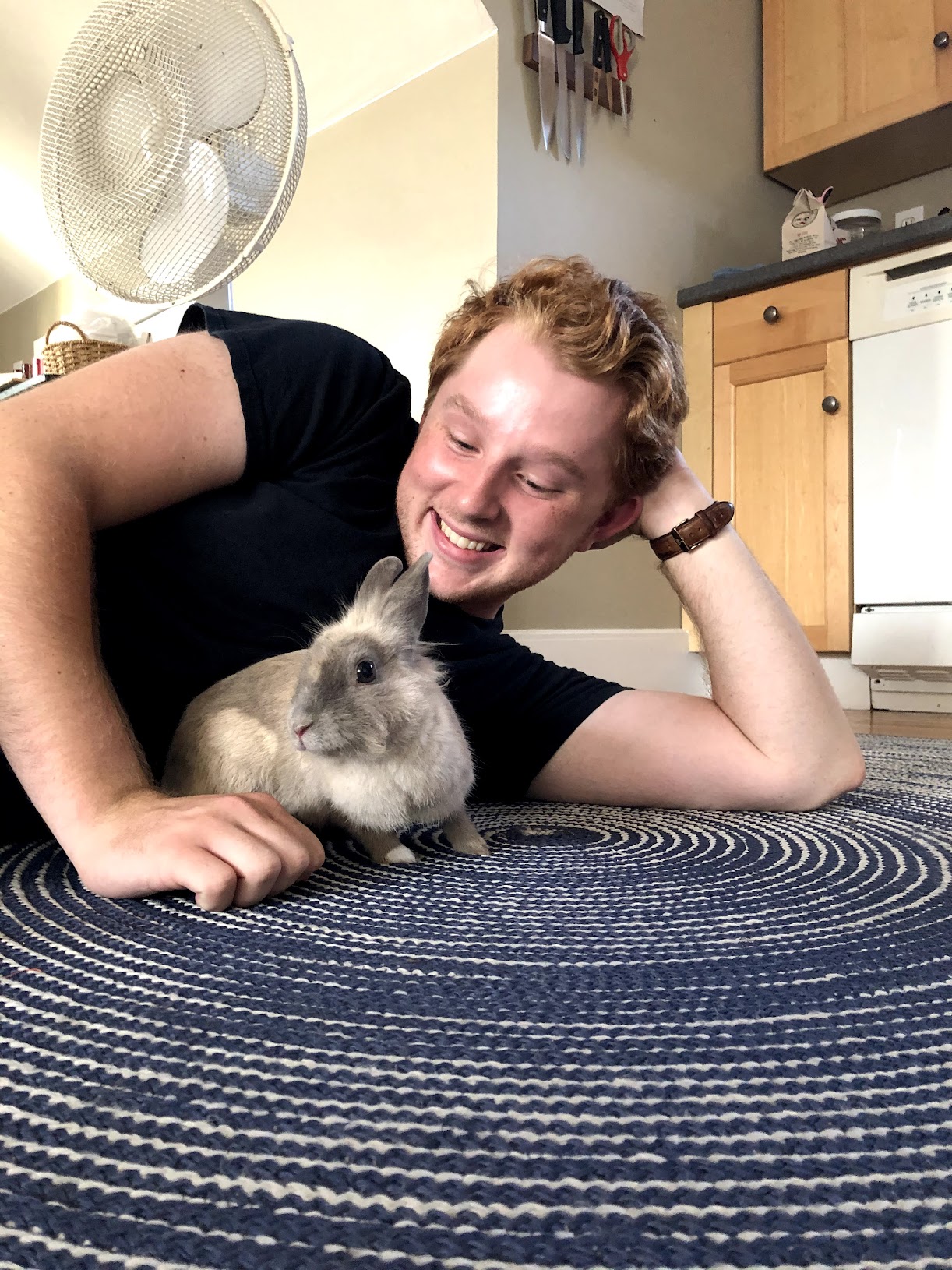 Alex lying on the kitchen floor with Nabby the bunny